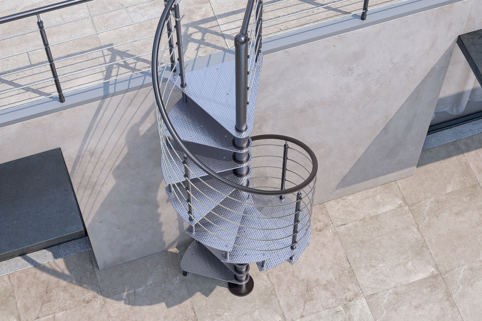 Vista dall'alto di una scala a chiocciola in metallo accanto a un edificio in pietra chiara con ringhiere sul tetto.