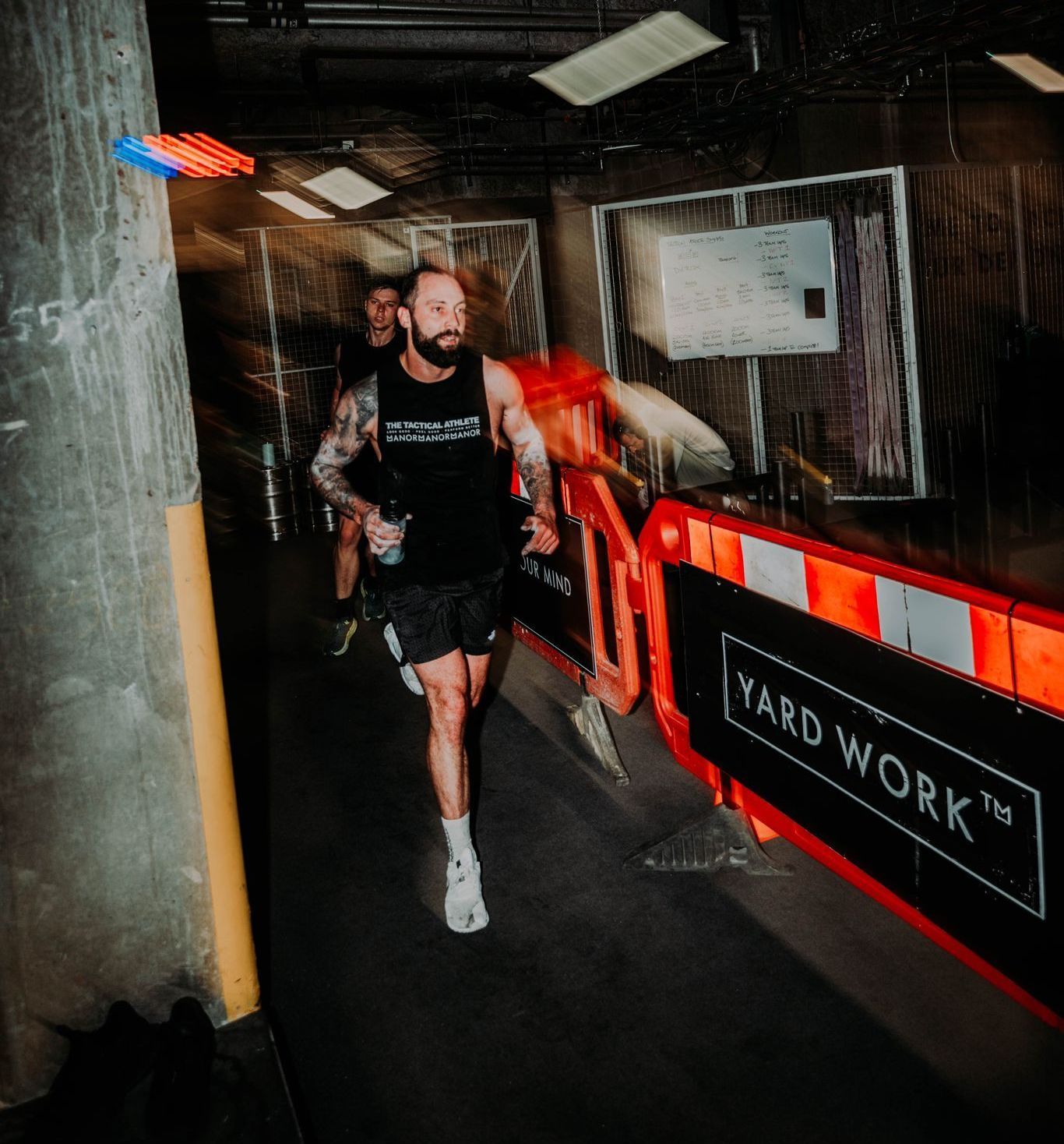 A man is running down a hallway with a sign that says yard work on it