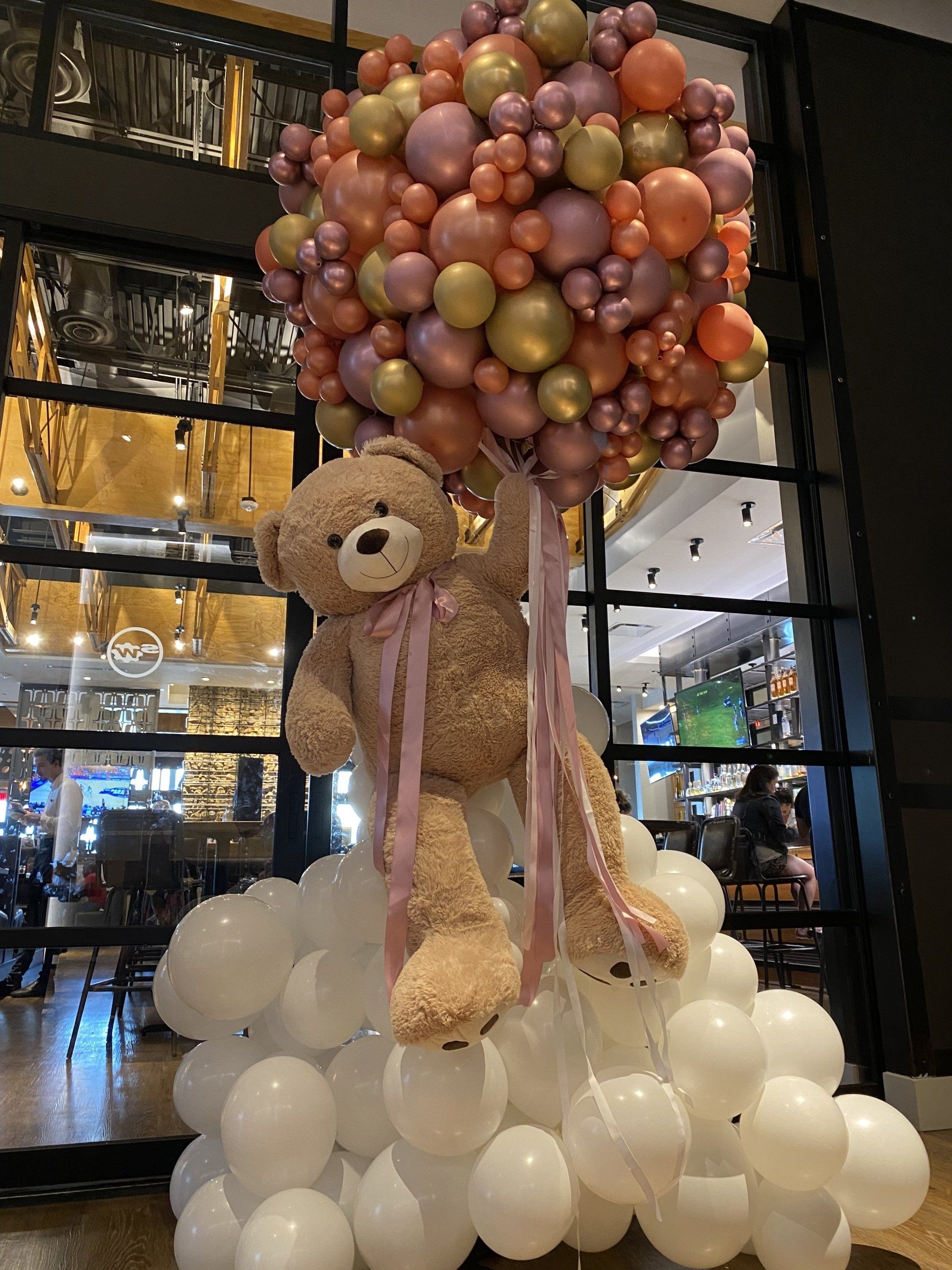 Large balloon teddy bear on a balloon cloud for a baby shower.