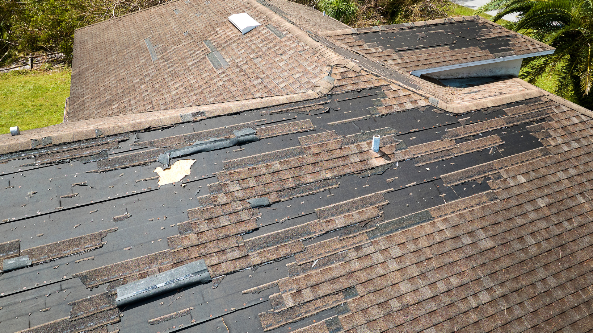 An aerial view of a roof that has been damaged by a storm.