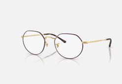 Un paio di occhiali rotondi su una superficie bianca.