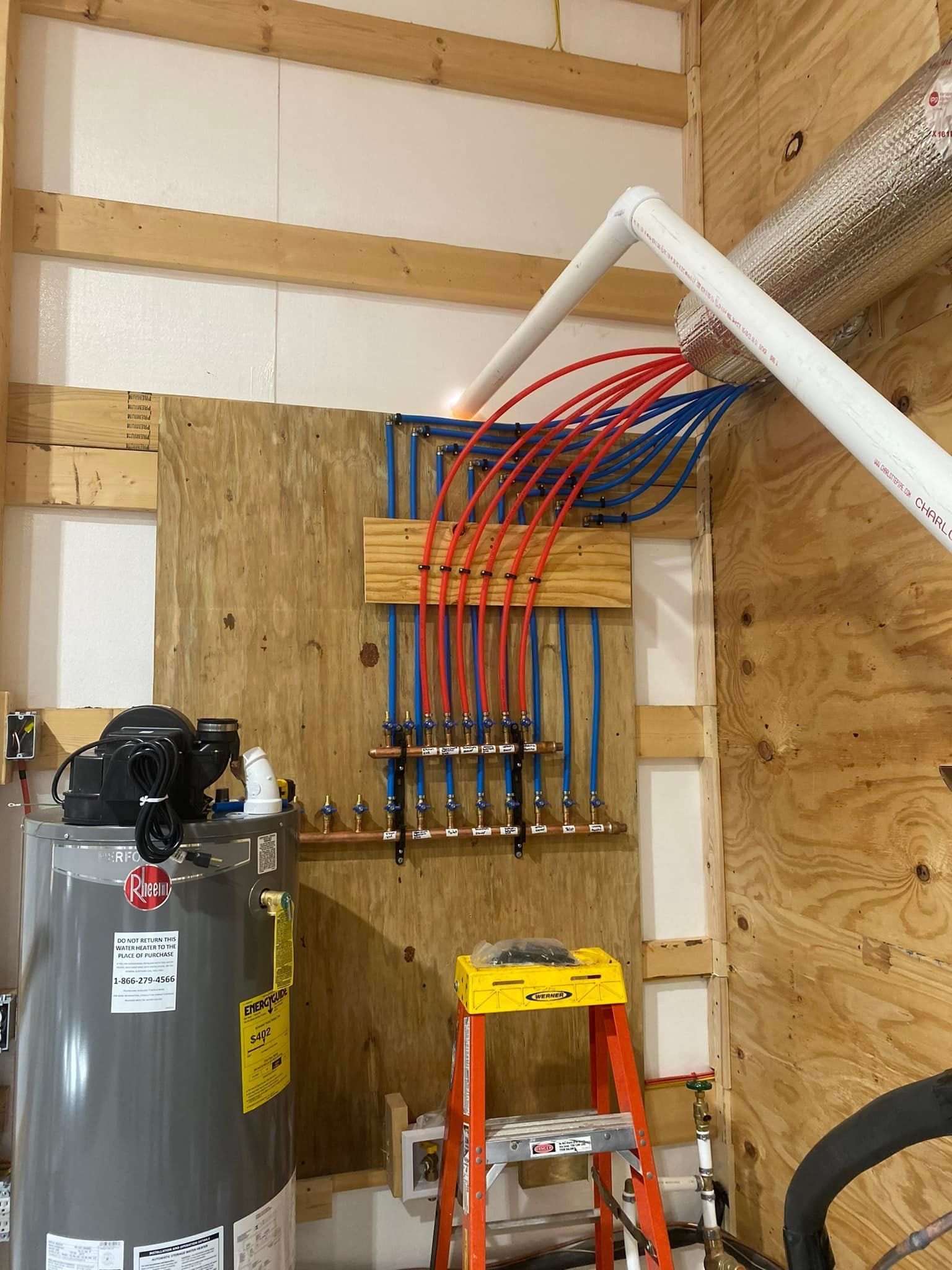 There is a water heater and a ladder in the room.