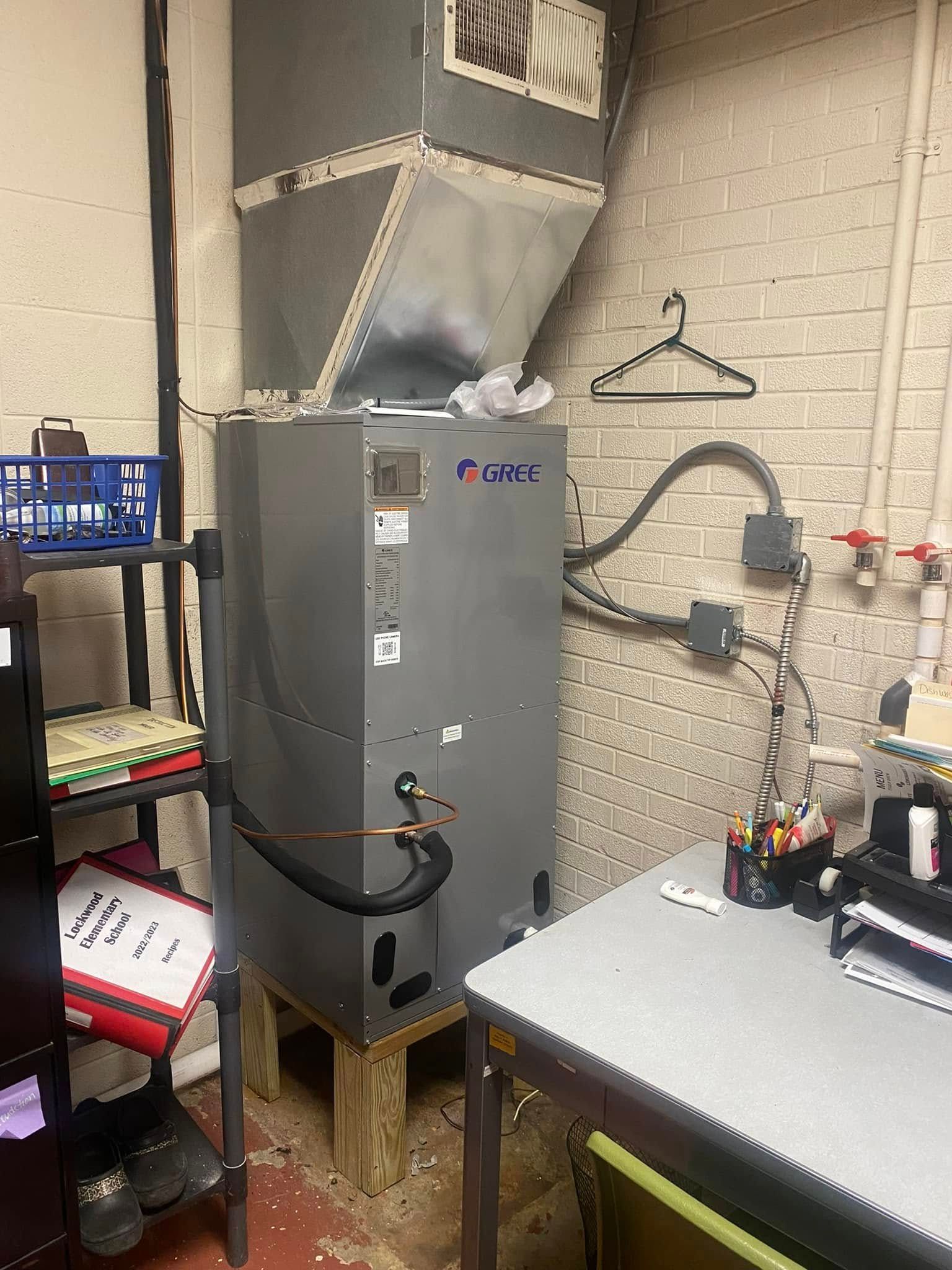 A room with a heater and a desk in it.