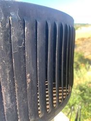 A close up of a black object with holes in it.