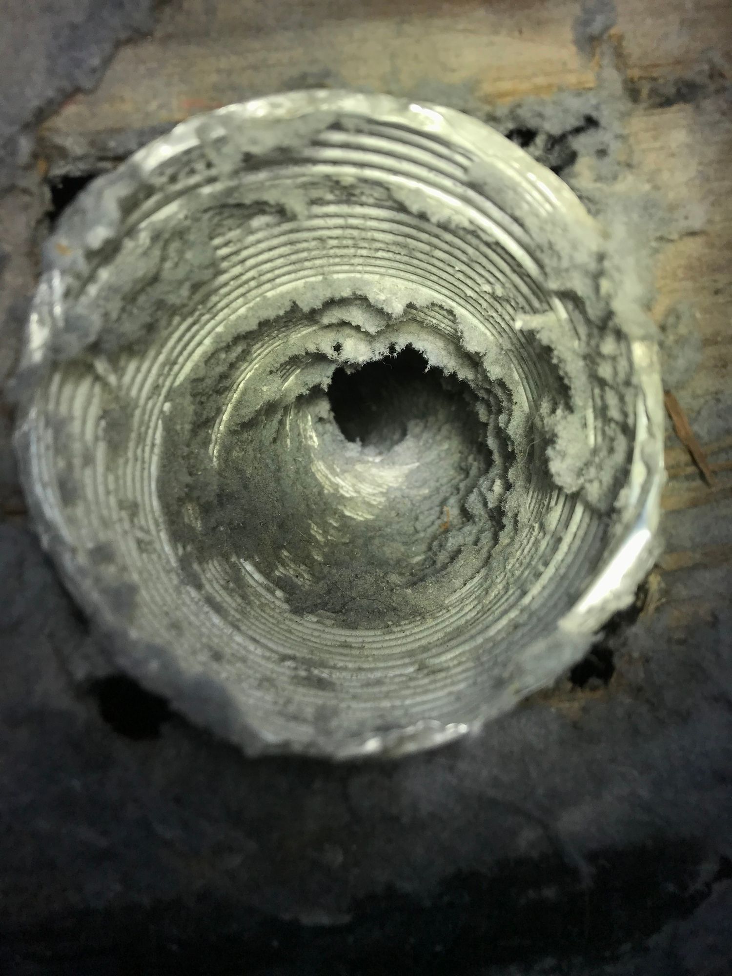 A close up of a metal object with a hole in the middle.