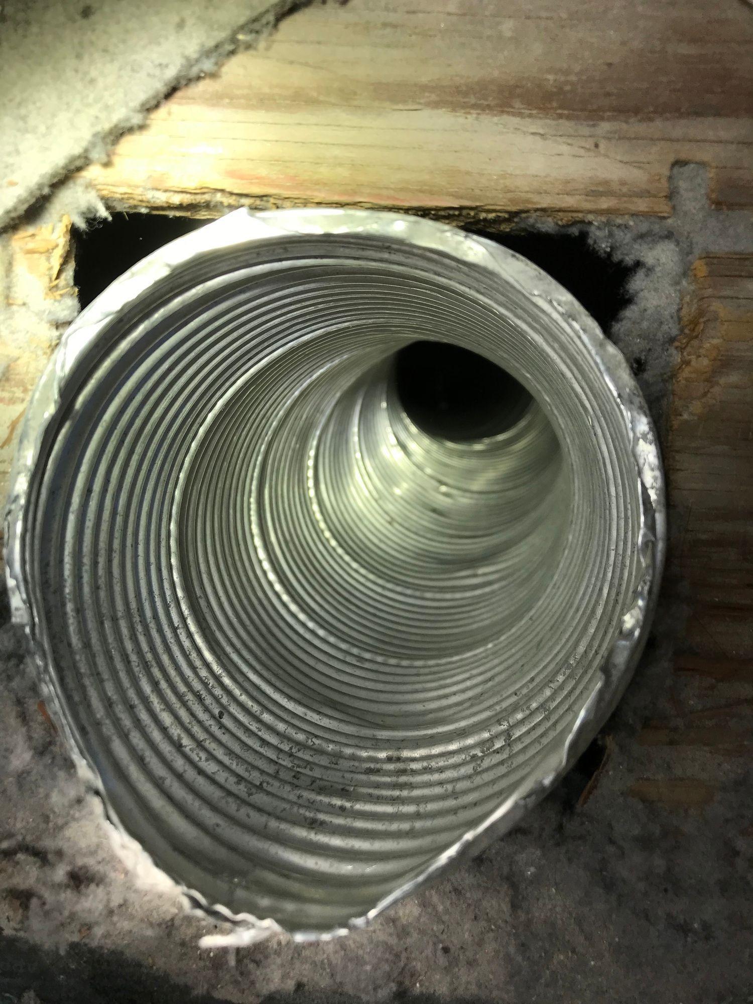A close up of a duct with a hole in it.