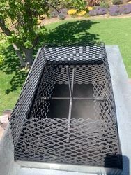 A metal fence is sitting on top of a concrete surface.