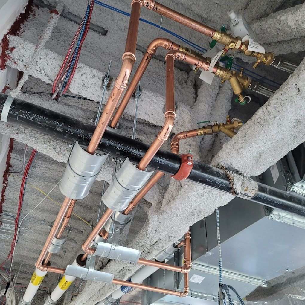 Copper pipes are hanging from the ceiling of a building
