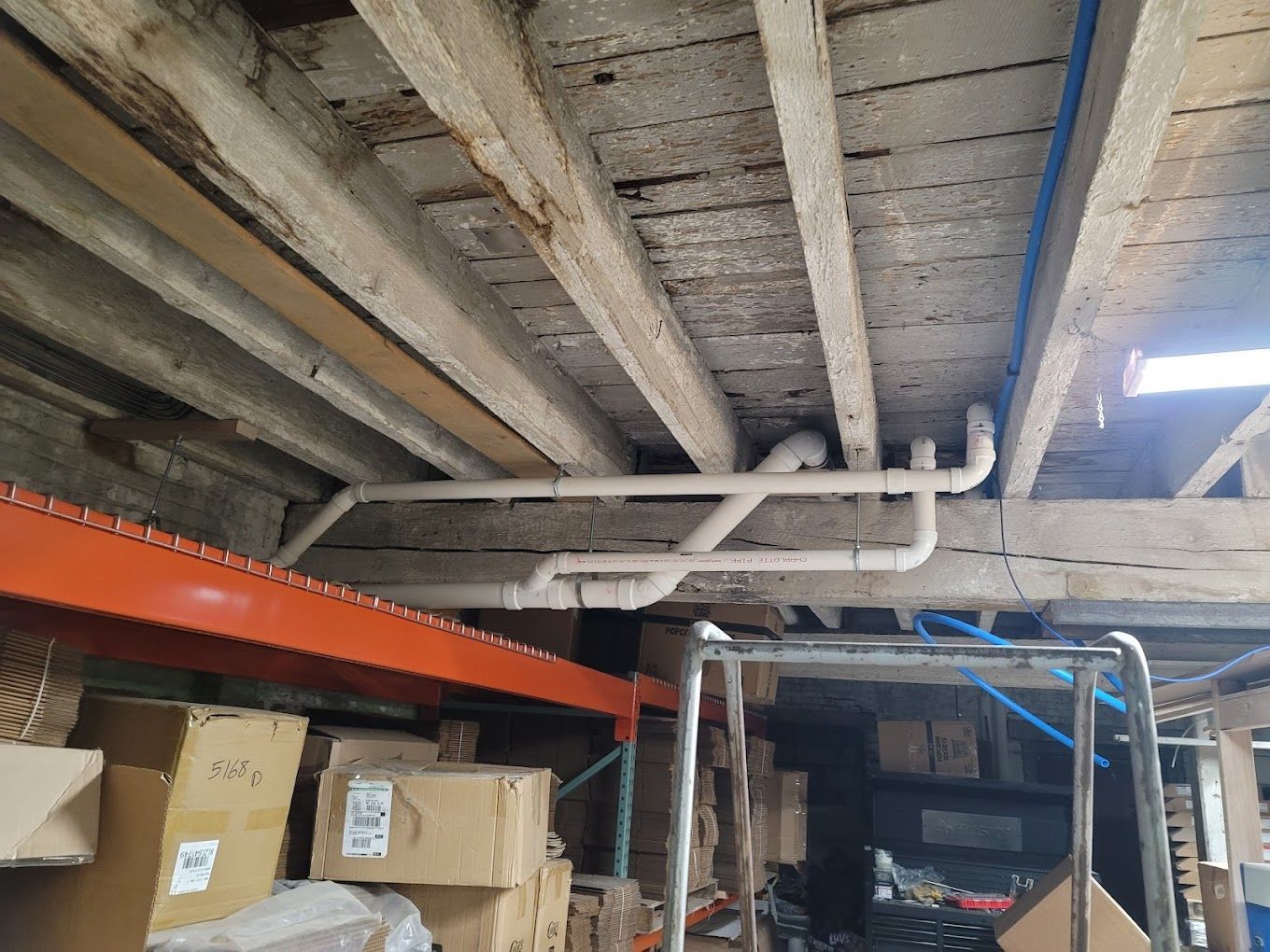 A warehouse filled with lots of boxes and pipes.