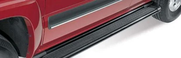 Red car with black side running board and silver trim on a white background