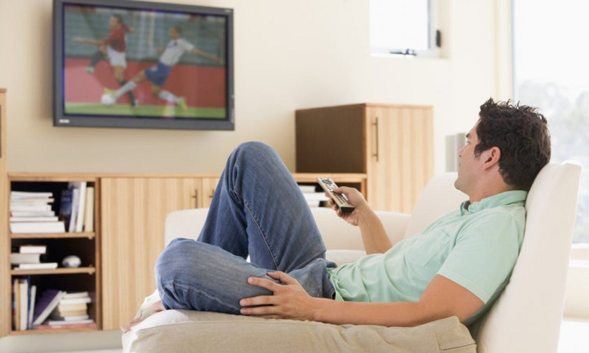 Image of a man watching Soccer on TV