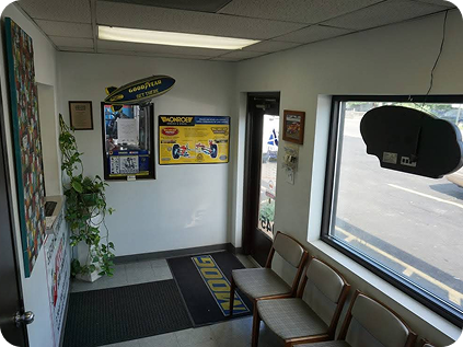 A waiting room with a sign on the wall that says bud | Safari Automotive