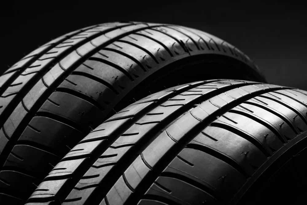 Black and White Tires Stacked, Showing Detailed Tread Patterns — Wheel Alignment Centre in Braitling, NT