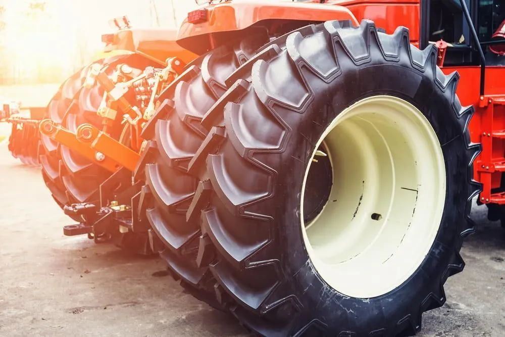 Orange Tractor With Large Black Tires and White Rims — Wheel Alignment Centre in Braitling, NT