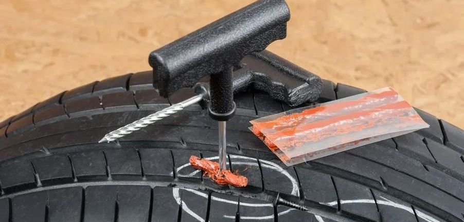 A tire being repaired with a puncture repair kit. — Wheel Alignment Centre in Braitling, NT