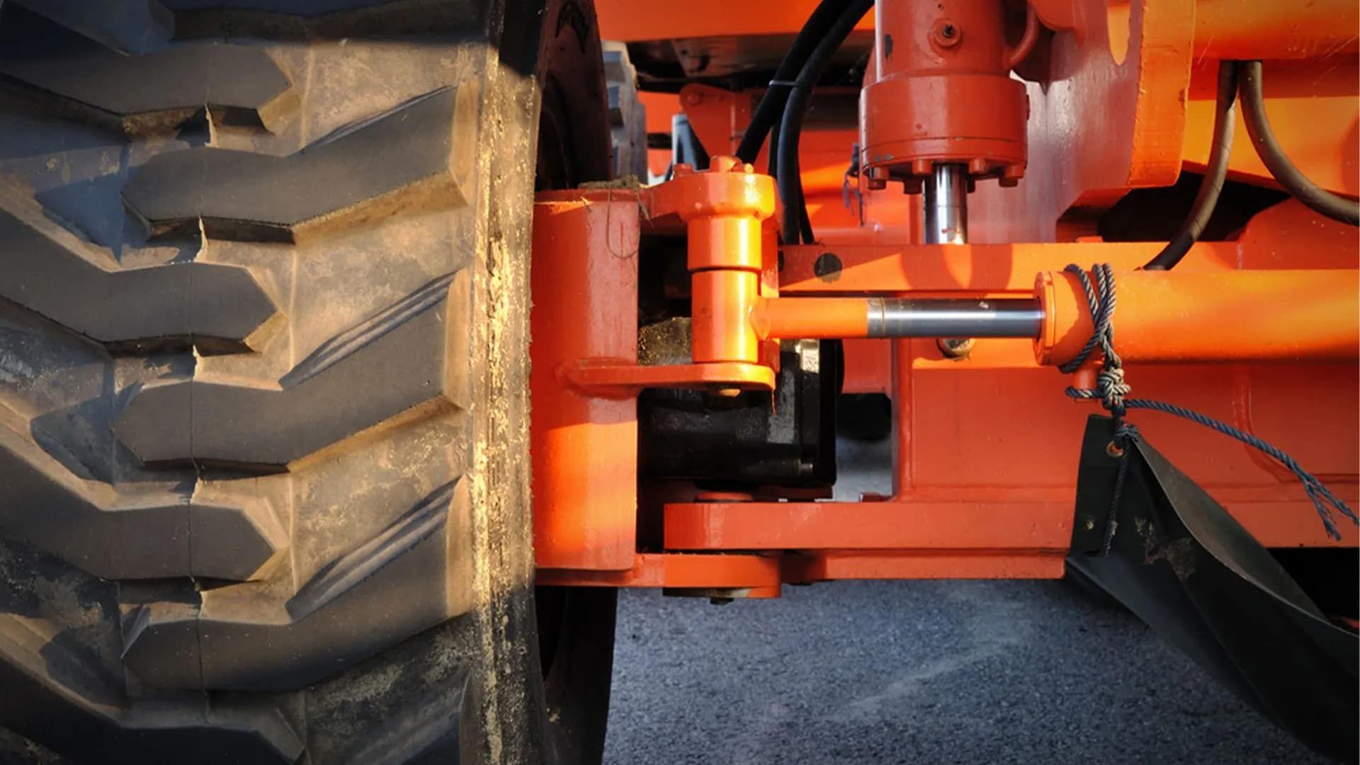 Orange Heavy Machinery Wheel and Hydraulic Arm, Tire Treads Visible — Wheel Alignment Centre in Braitling, NT