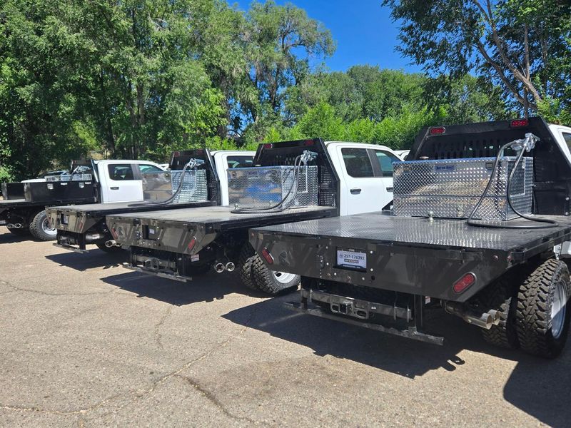 The back of a truck with a compressor on the bed.