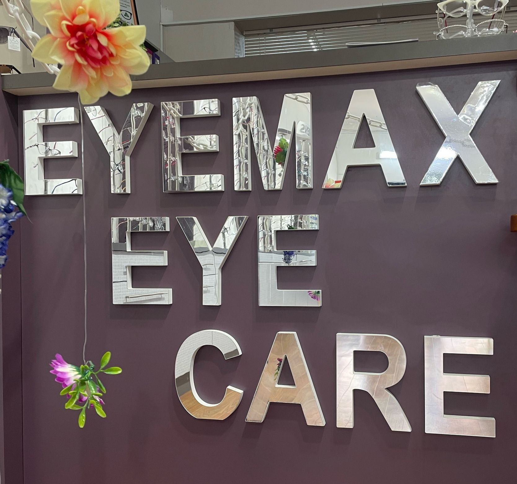 Eyemax Eyecare written on the counter — Optometrist in Wallsend, NSW