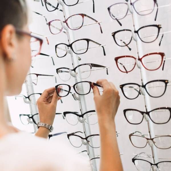Women holding New Glass Frame from the display— Optometrist in Wallsend, NSW