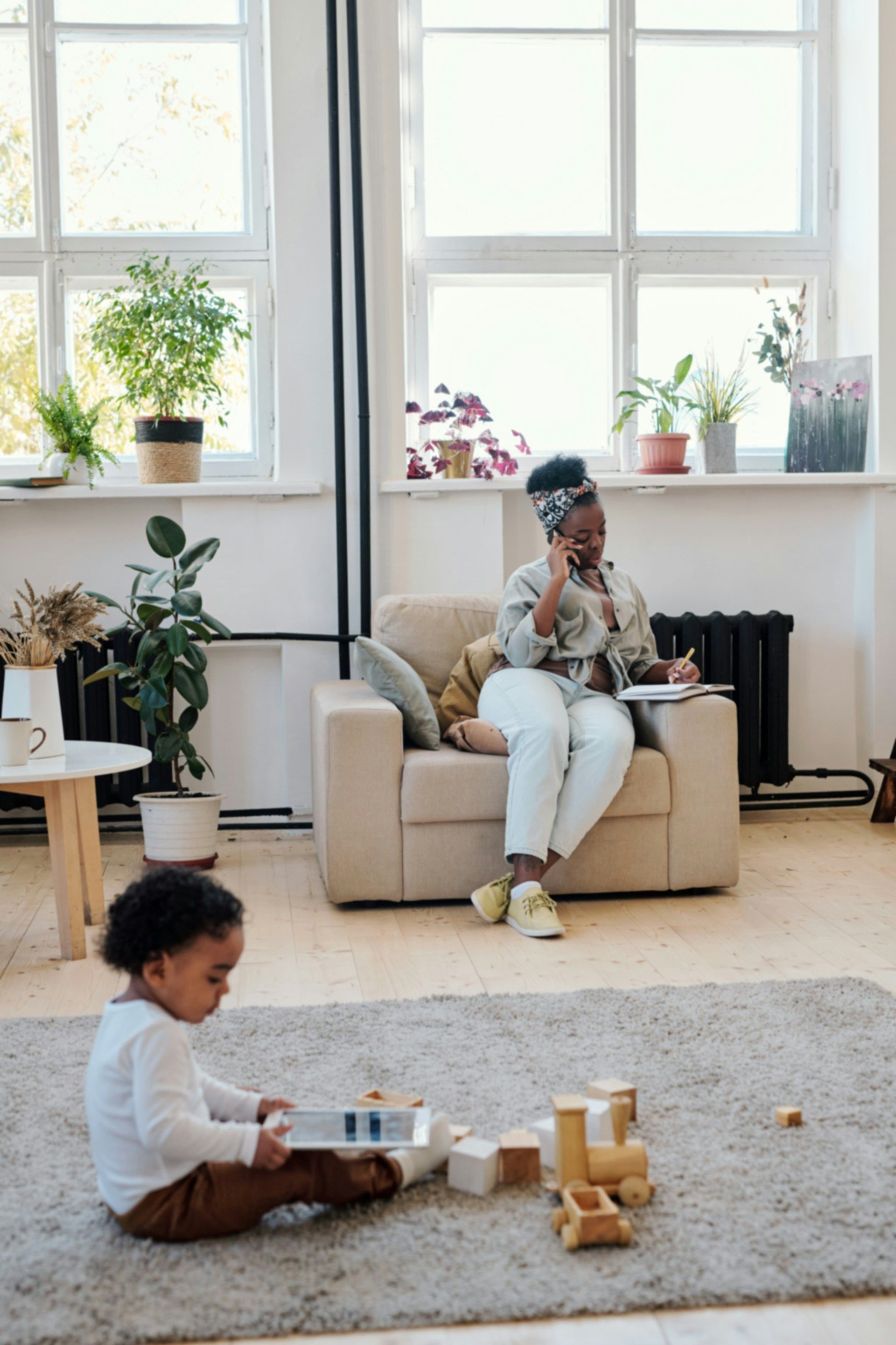 A group of people are sitting around a table shaking hands.