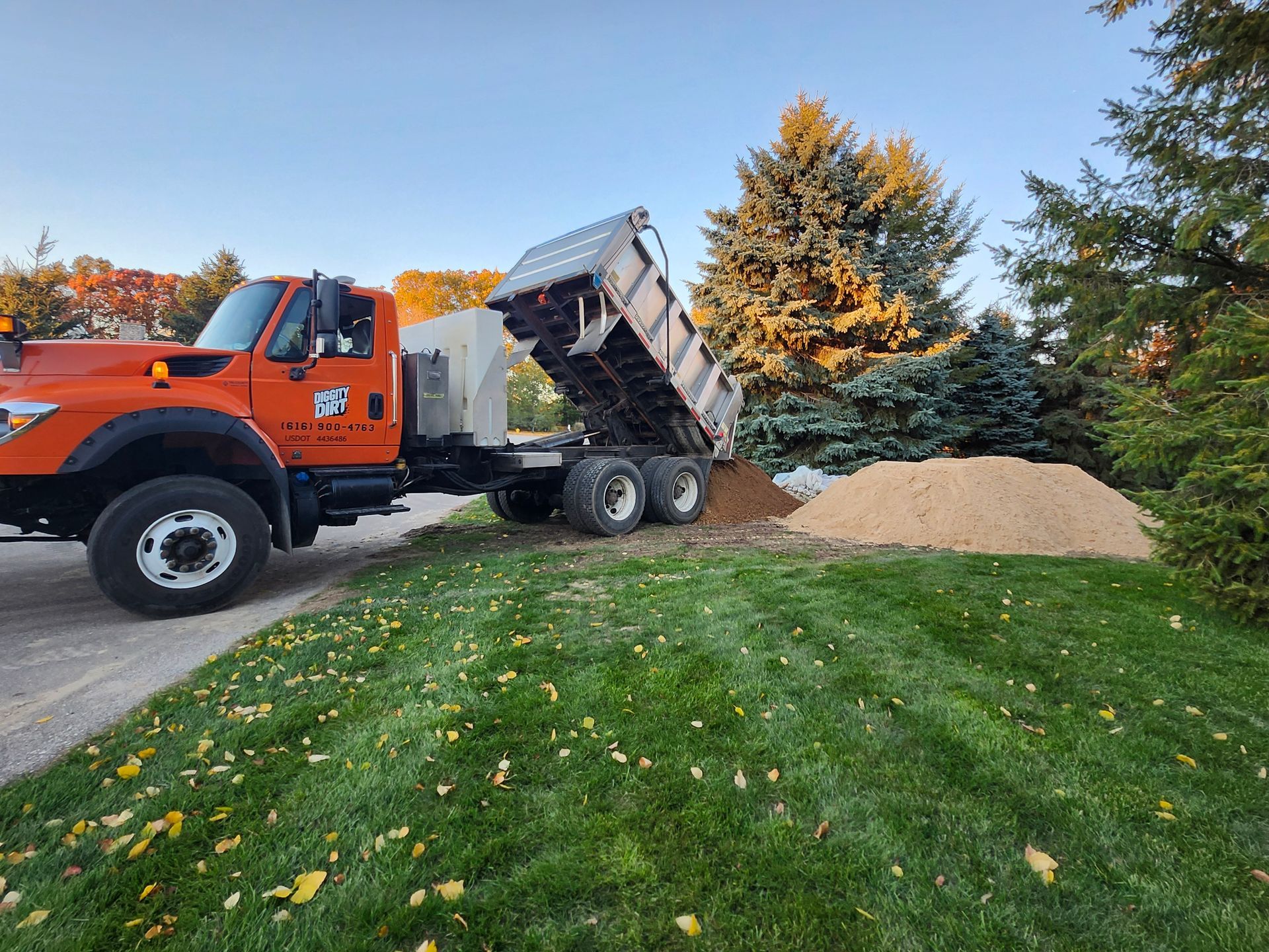 A man wearing gloves is driving a bulldozer on a construction site.