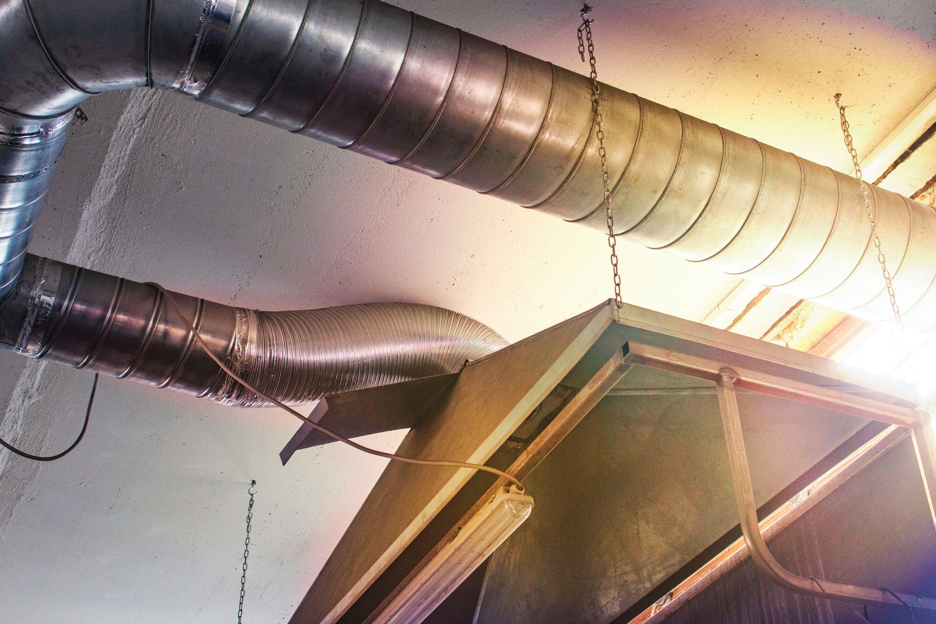 Air ducts and ventilation system in a building interior, metallic.