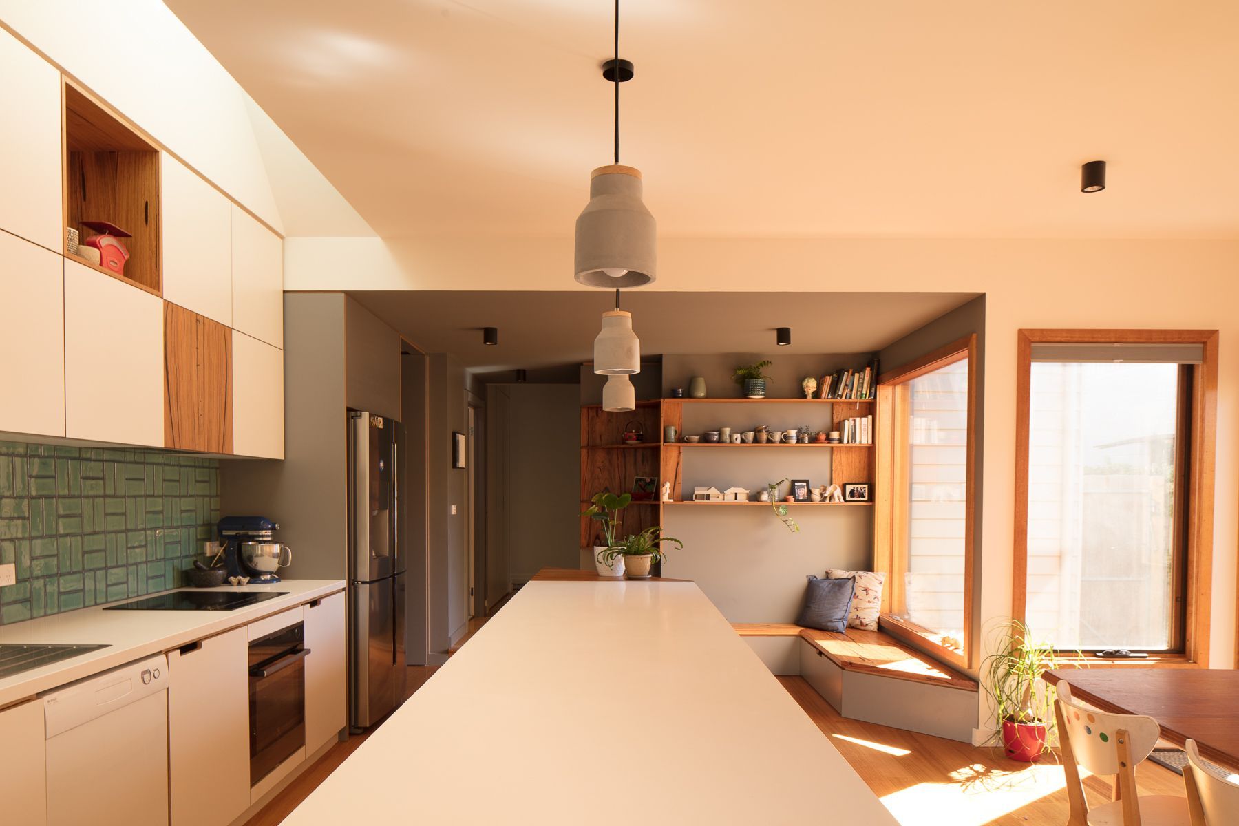 A kitchen with a large island bench in the middle of the room.