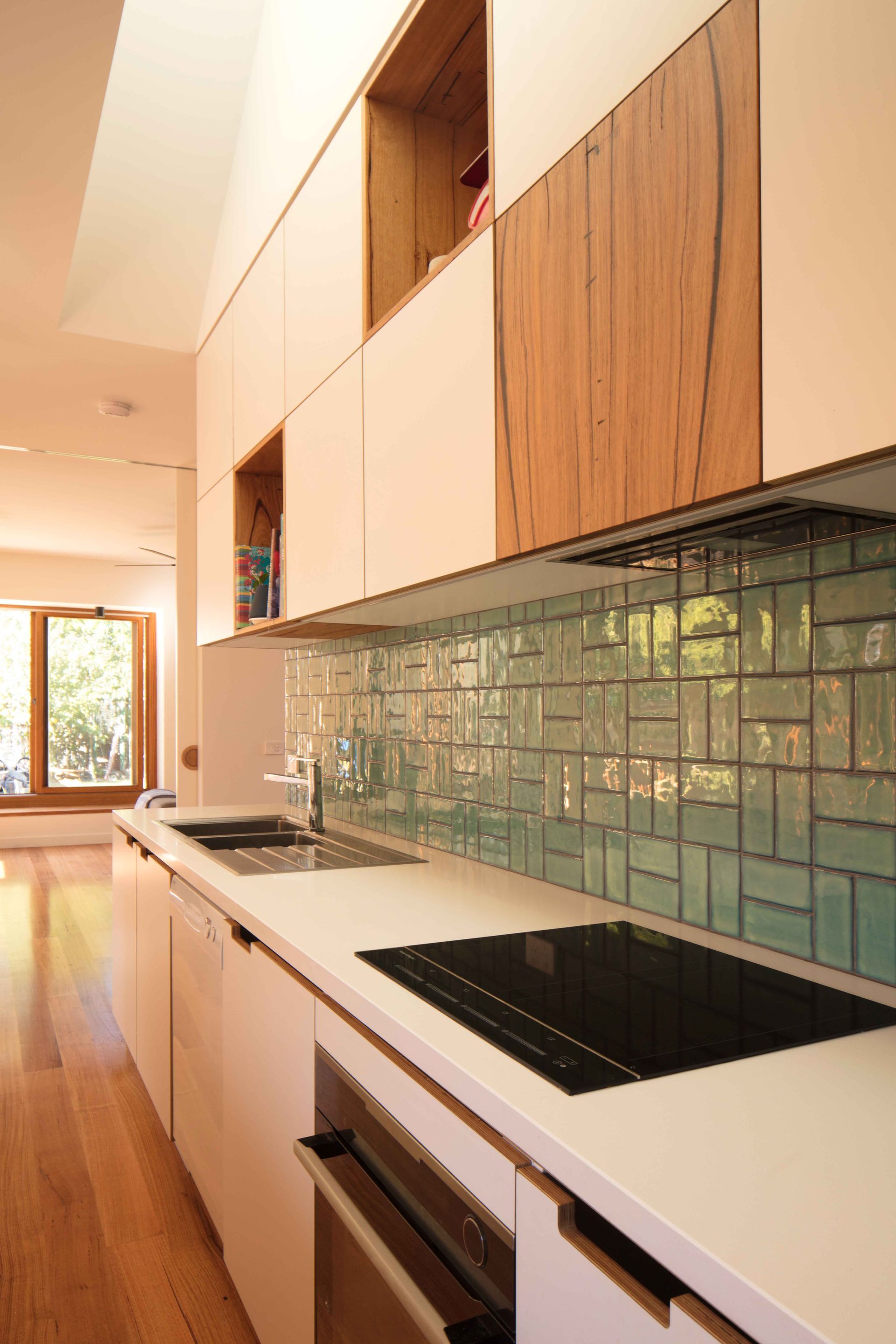 A kitchen with a stove top oven and a sink.