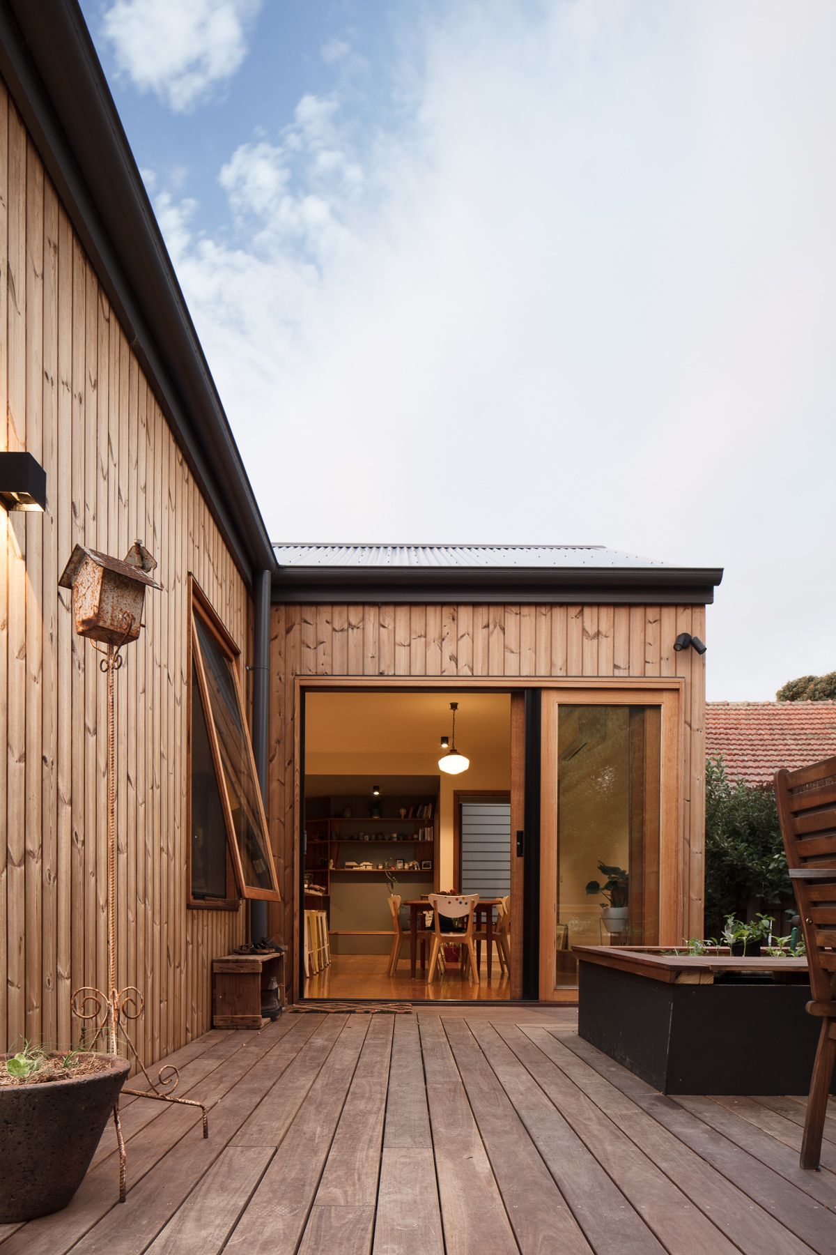 A wooden house with a large sliding glass door
