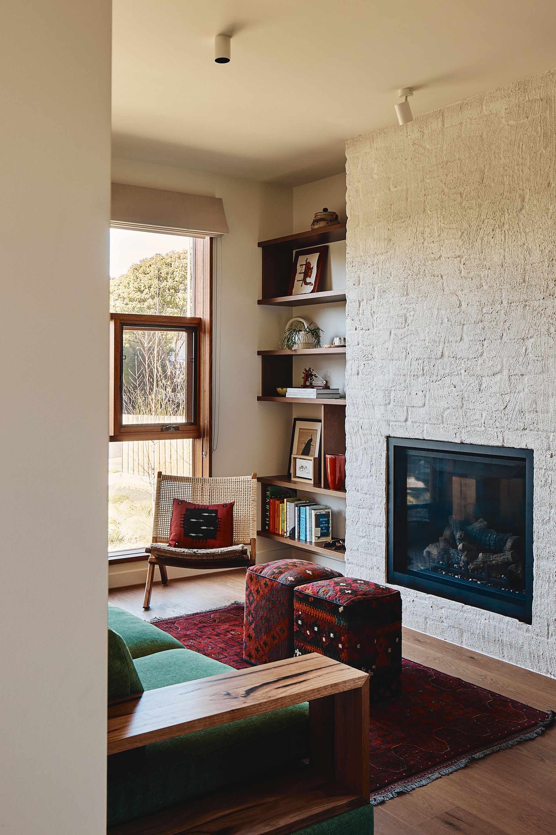 There is a fireplace in the middle of the living room.