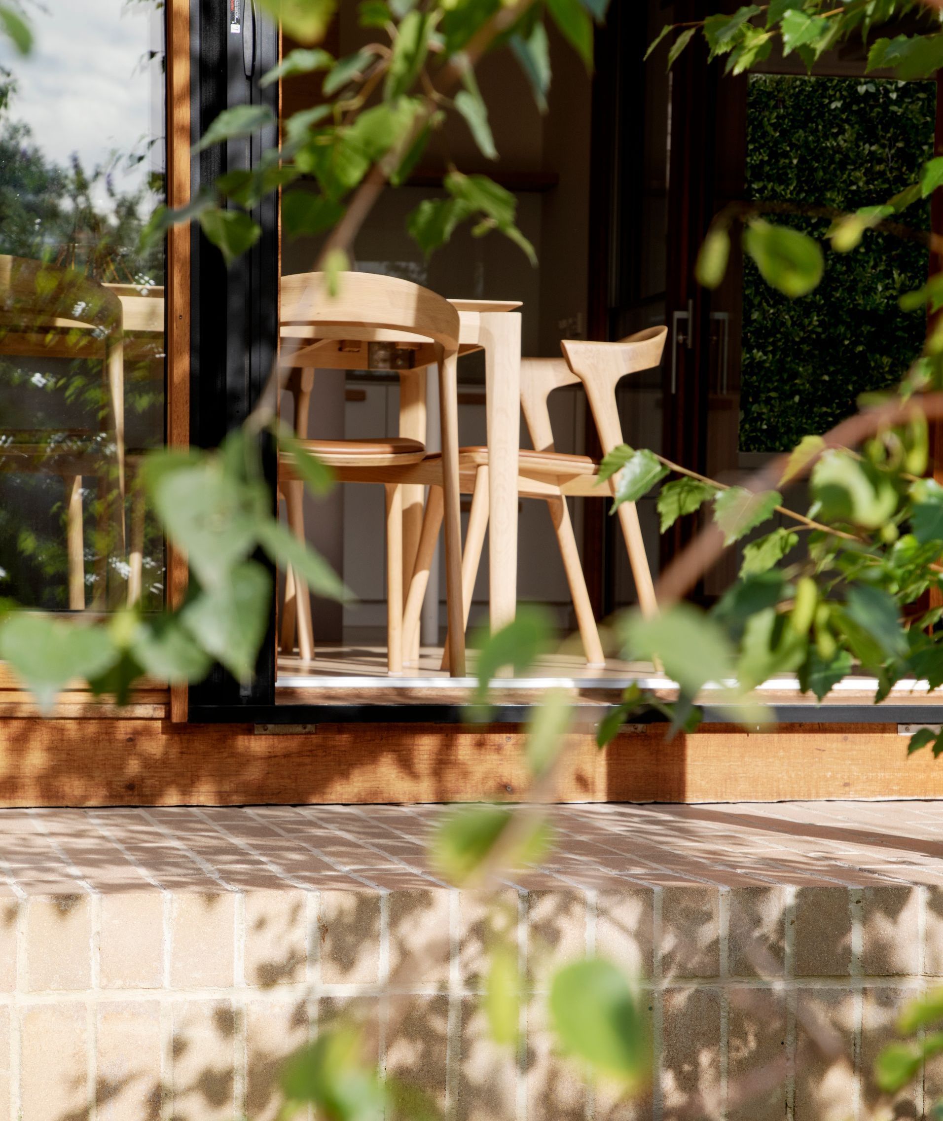 A table and chairs in front of a sliding glass door