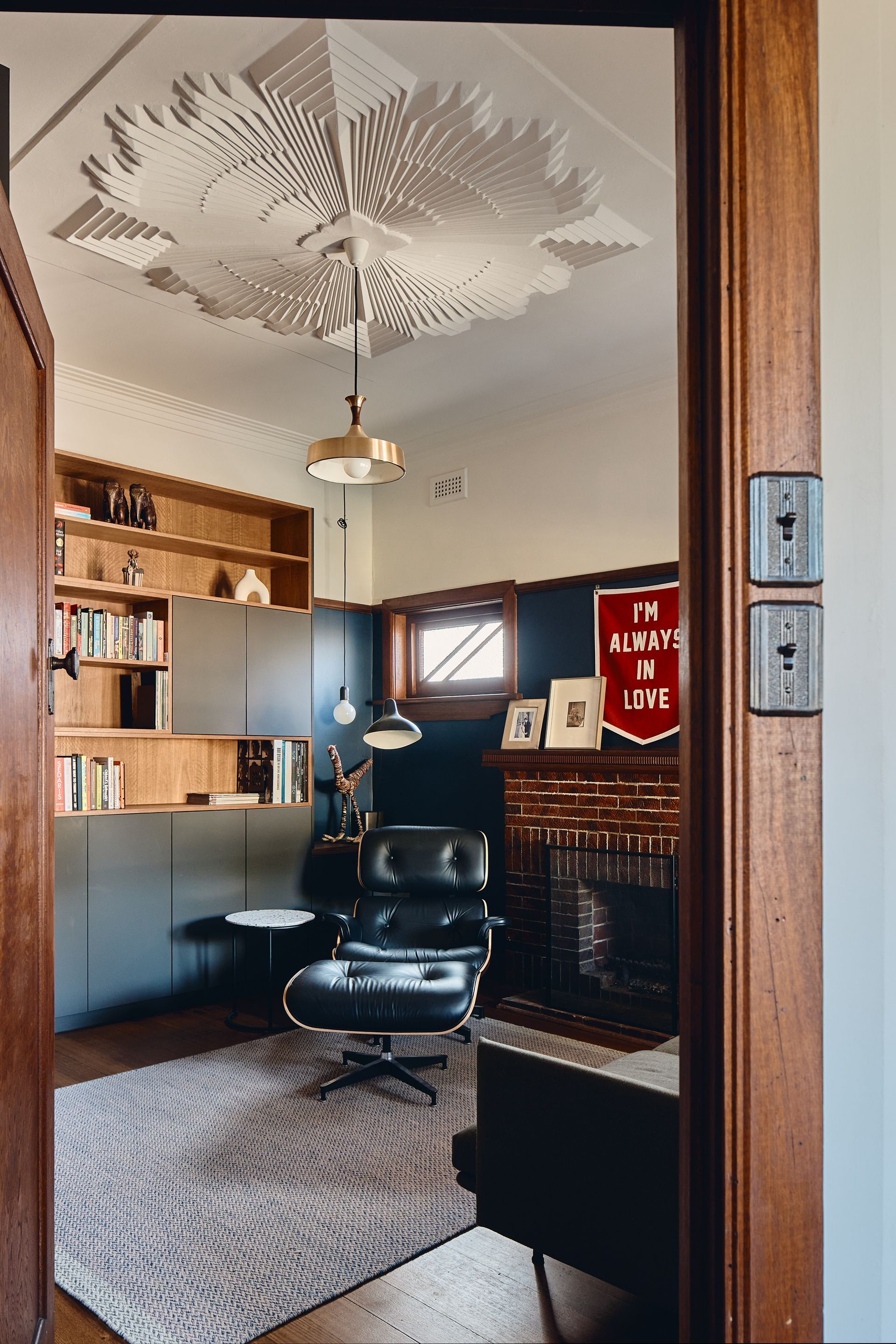 A room with a chair and a sign that says i 'm happy to live
