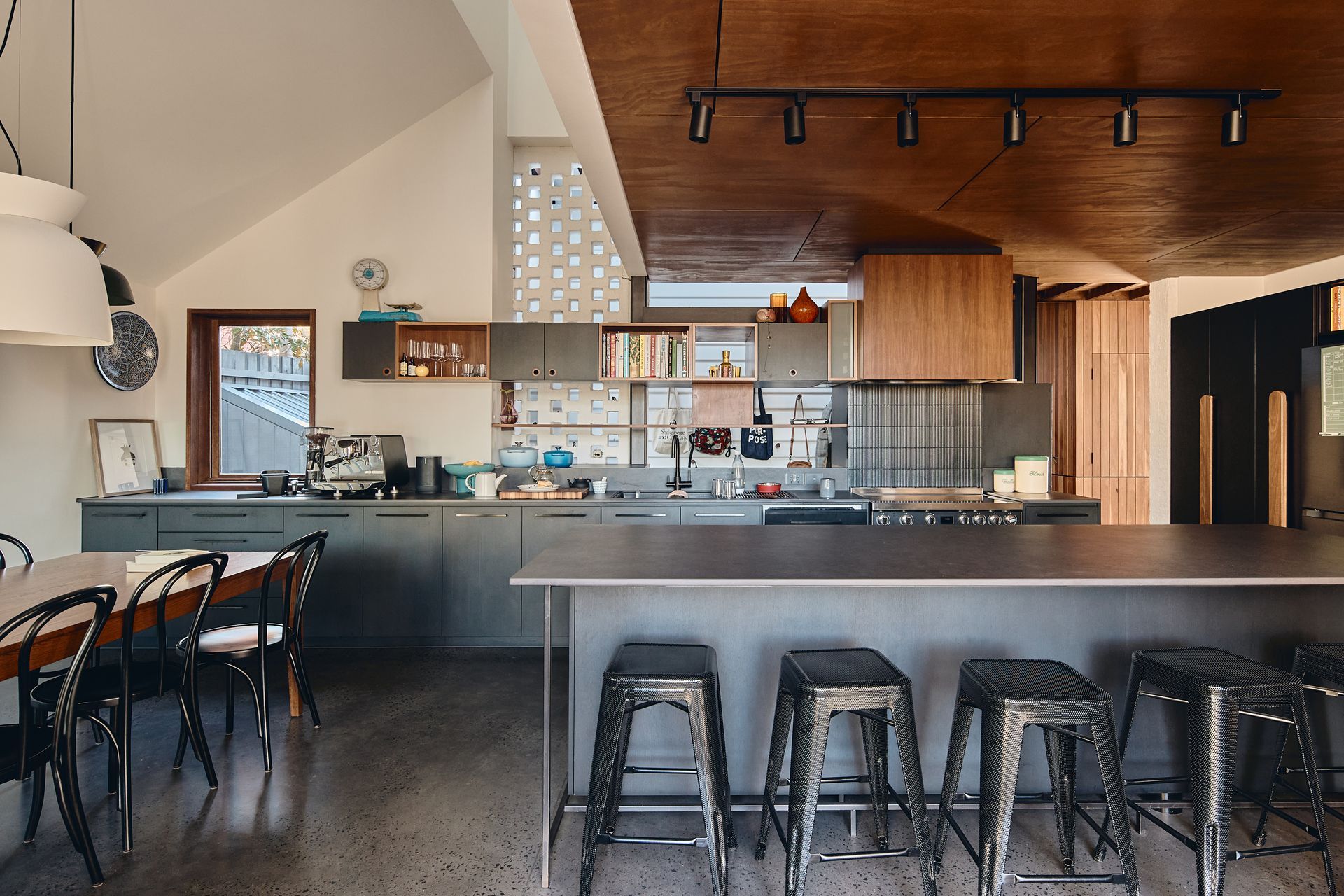 A kitchen with a large island and stools