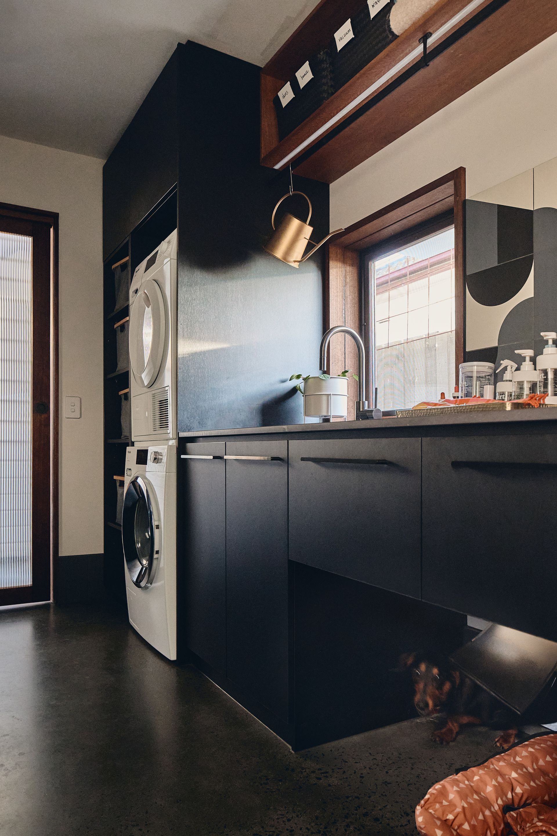 A laundry room with a washer and dryer stacked on top of each other