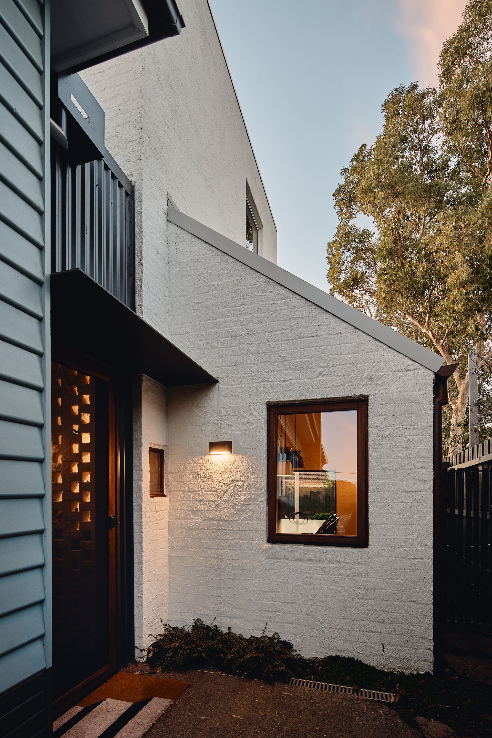 A white house with a window on the side of it
