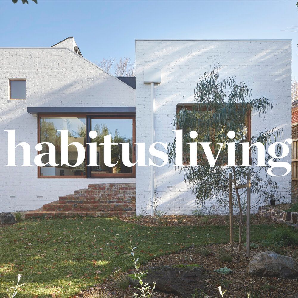 A white house with habitus living written on it