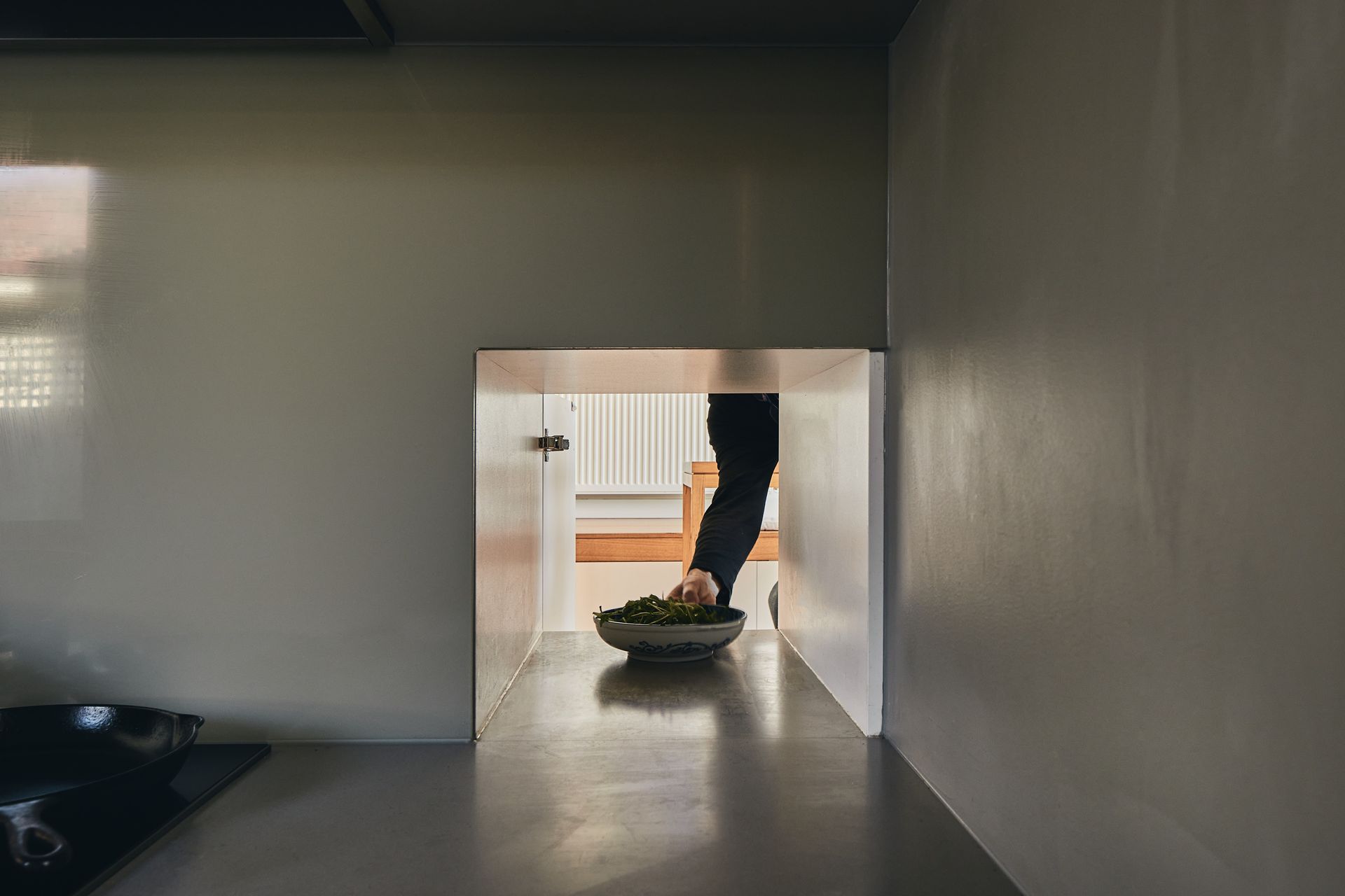 A person is walking through a doorway into a room.