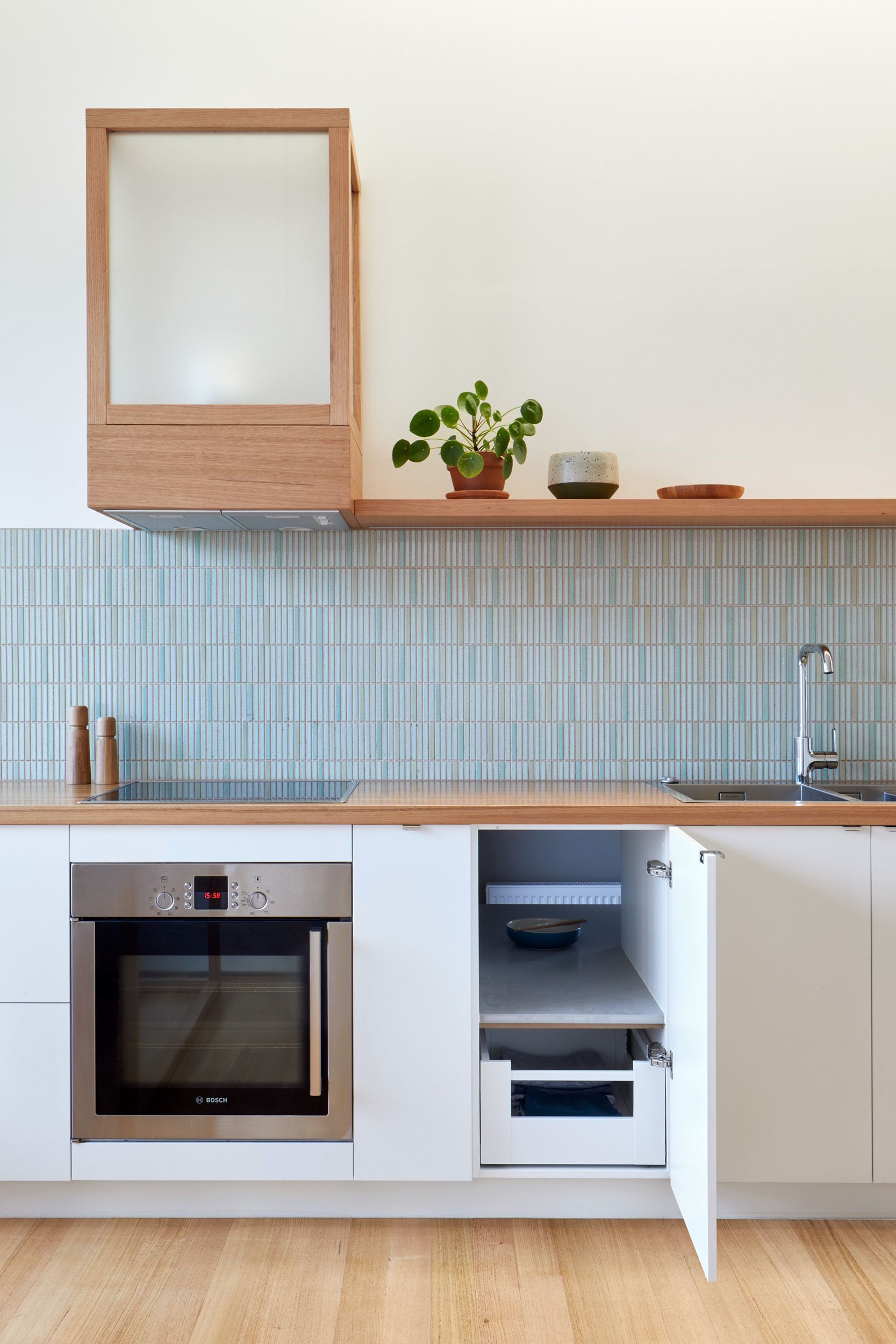 A kitchen with stainless steel appliances and white cabinets