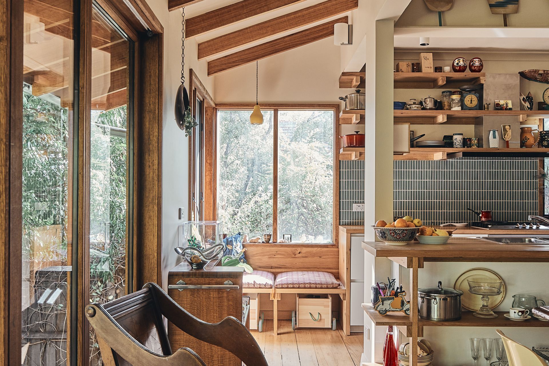 There is a chair in the middle of the room in the kitchen.