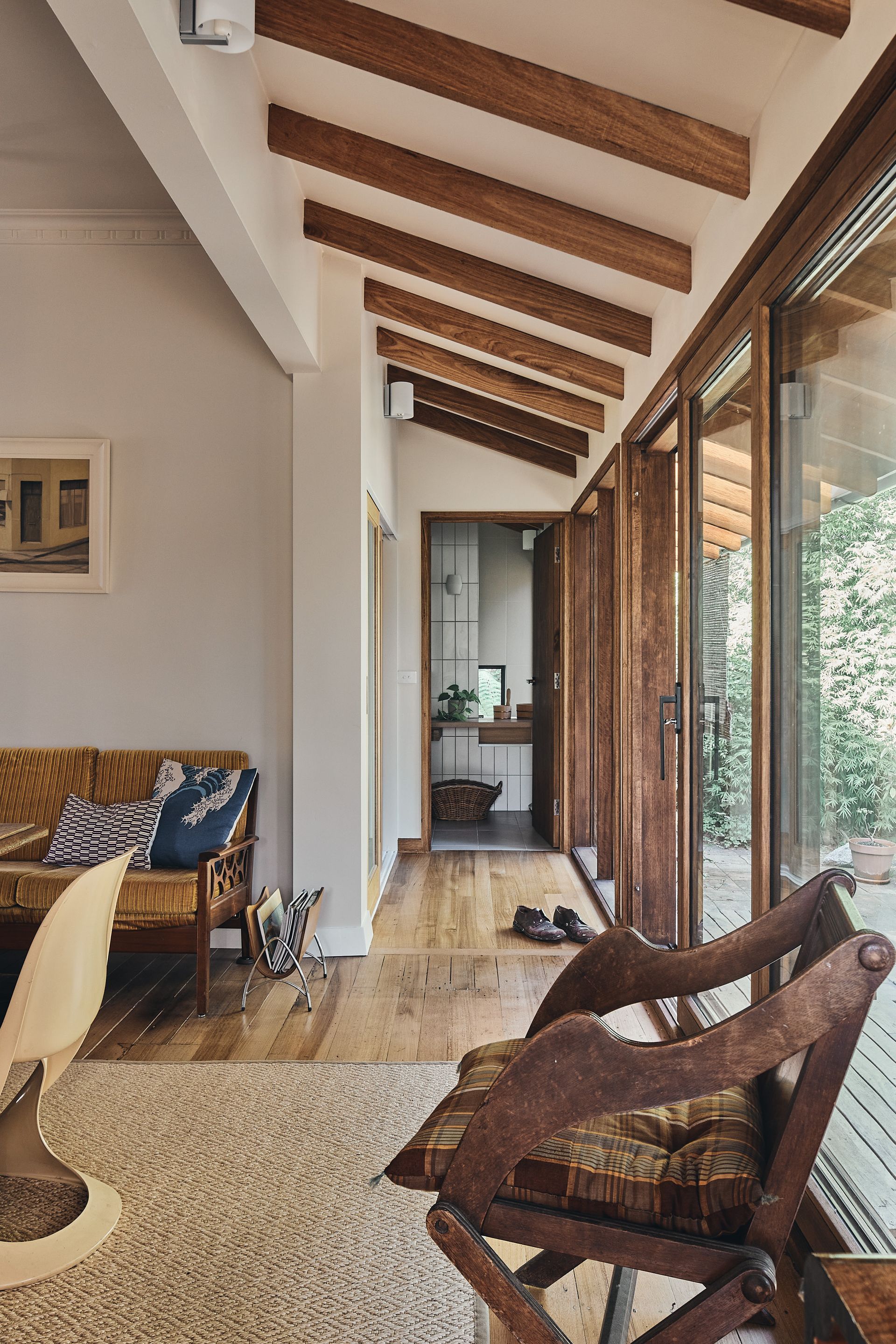 A living room with a couch , chair , and sliding glass doors.