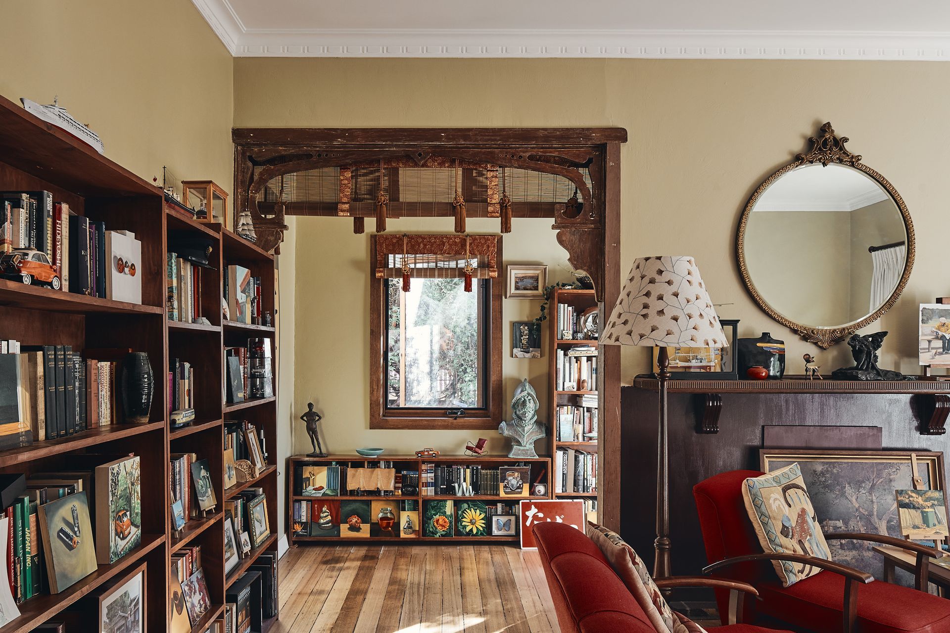 A living room filled with furniture and bookshelves.