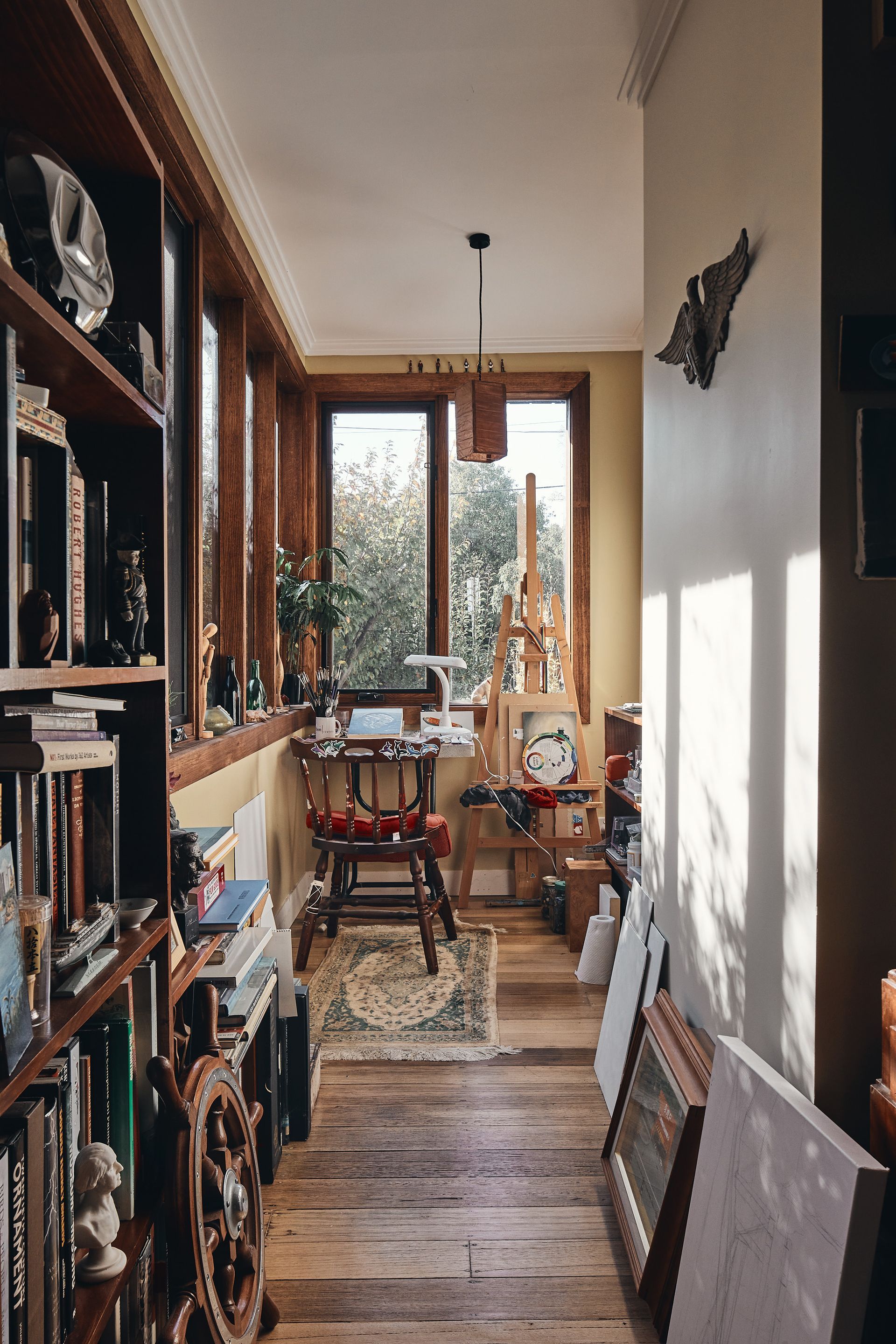 A room with a wooden floor and a lot of books on the shelves.