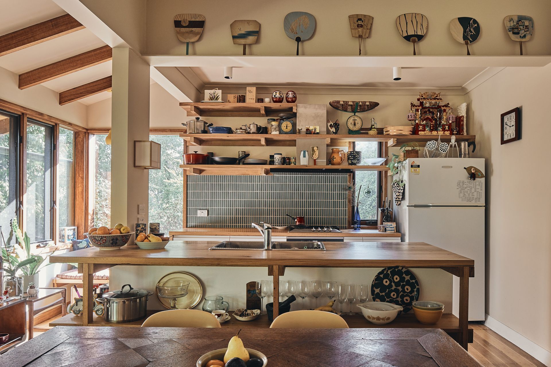 A kitchen with a table and chairs and a refrigerator