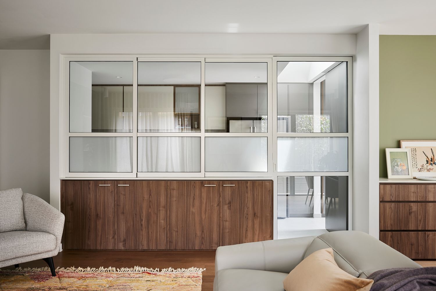 A living room with a couch , chair , and sliding glass doors.