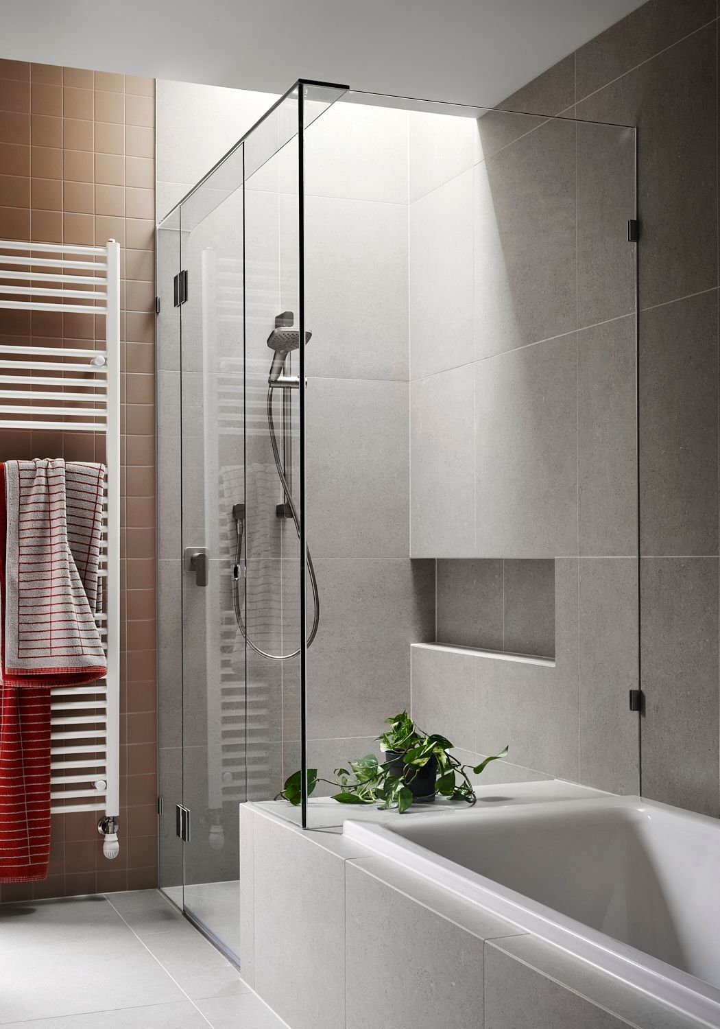 A bathroom with a walk in shower and a bathtub.
