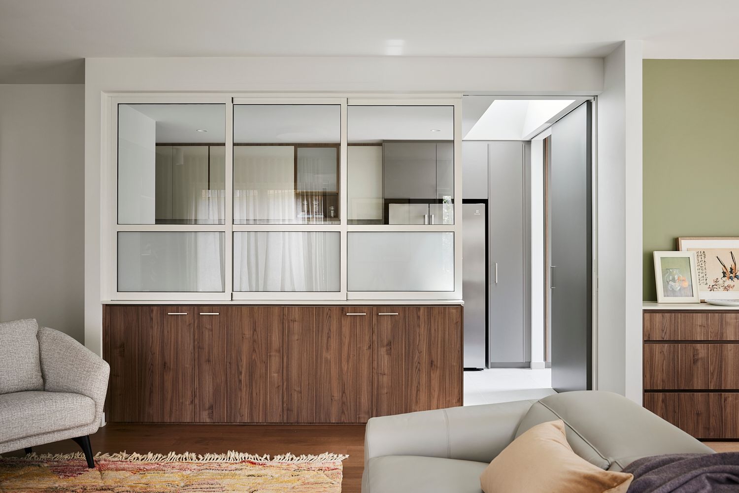 A living room with a couch , chair , and sliding glass doors.