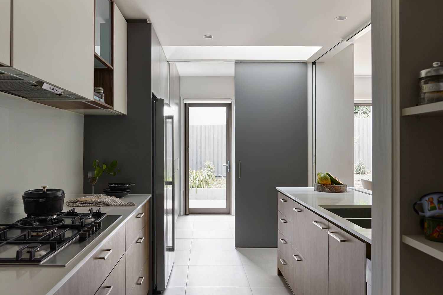 A kitchen with a stove top oven and a sink
