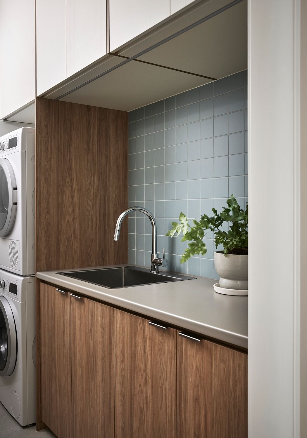 A laundry room with a sink , washer and dryer.