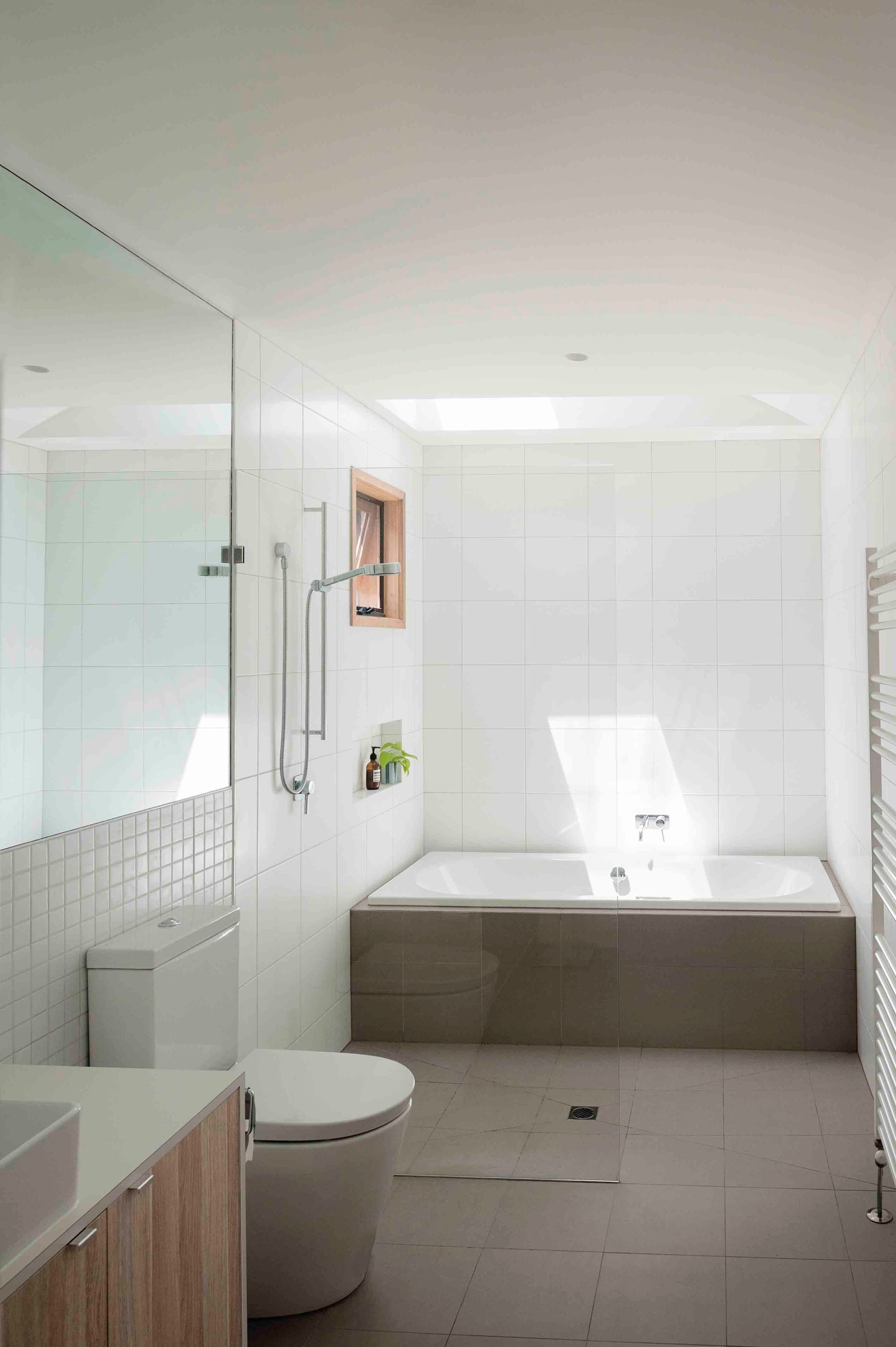 A bathroom with a toilet , sink , tub and shower.