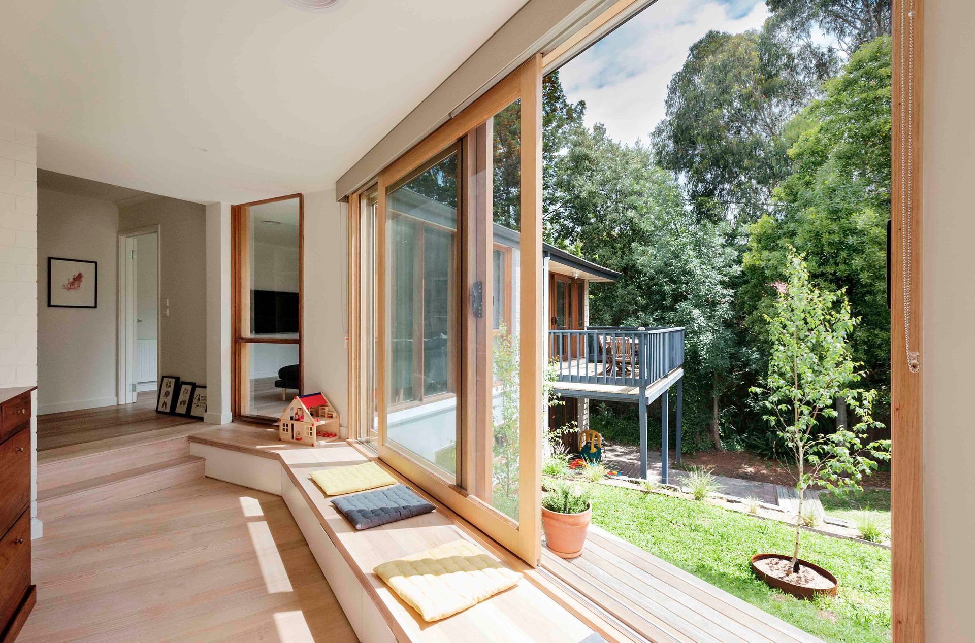 A large window with a view of a house and trees